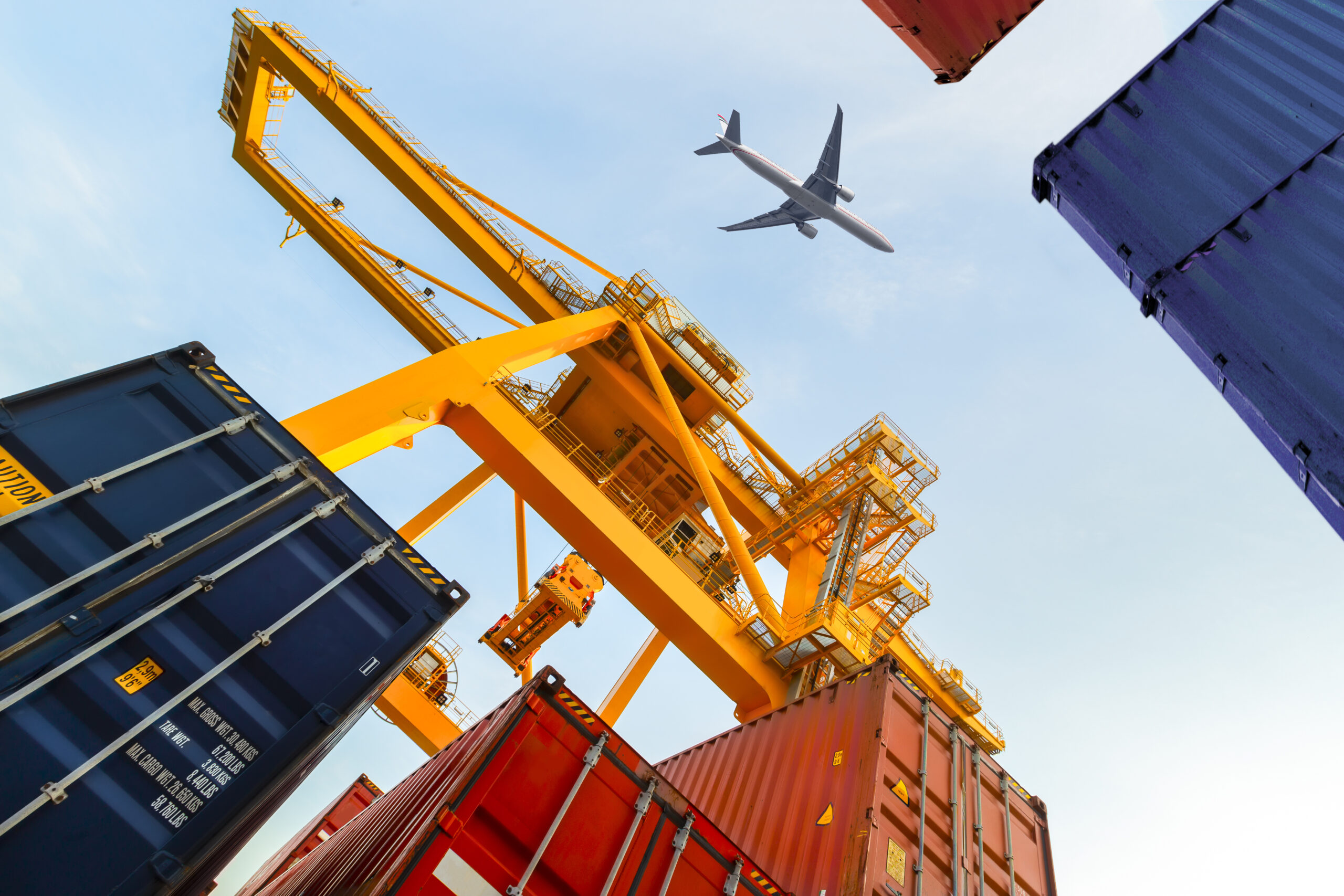 Container Cargo freight ship with working crane loading bridge in shipyard at twilight for Logistic Import Export background